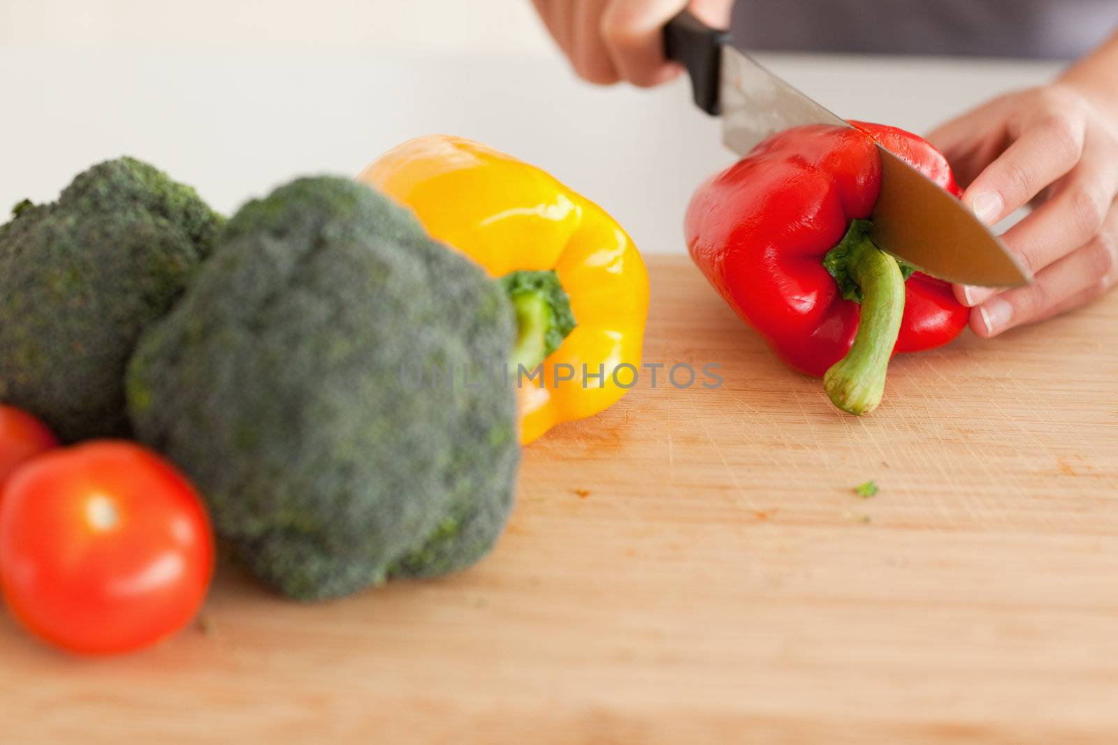 Woman hands cooking vegetables while standing in the kitchen