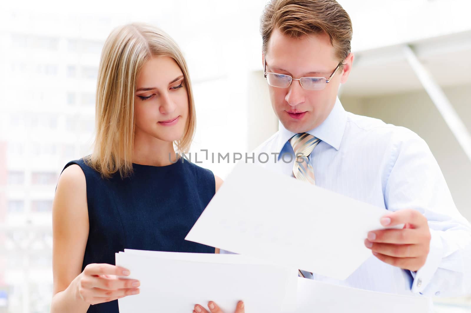 business man and business woman in the office to discuss reports by adam121