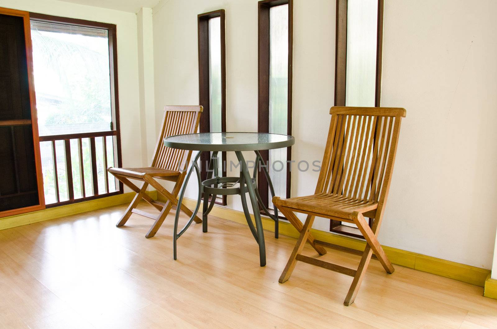 The living room is decorated with wooden chair.