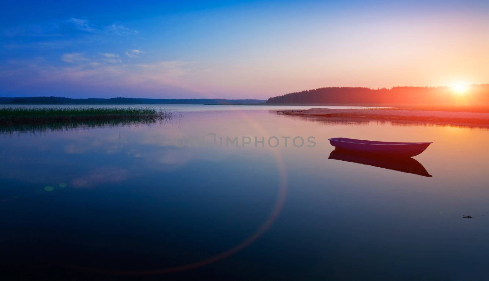 Sunrise over the lake. The first rays of sun.