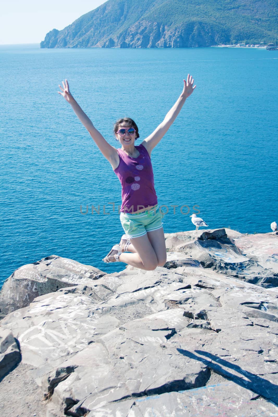 girl jumping on the background of the sea outdoors shooting