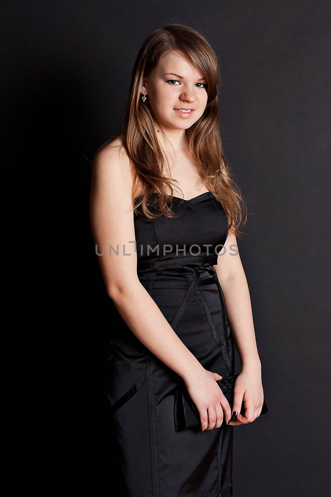 Beautiful girl in black dress photography studio