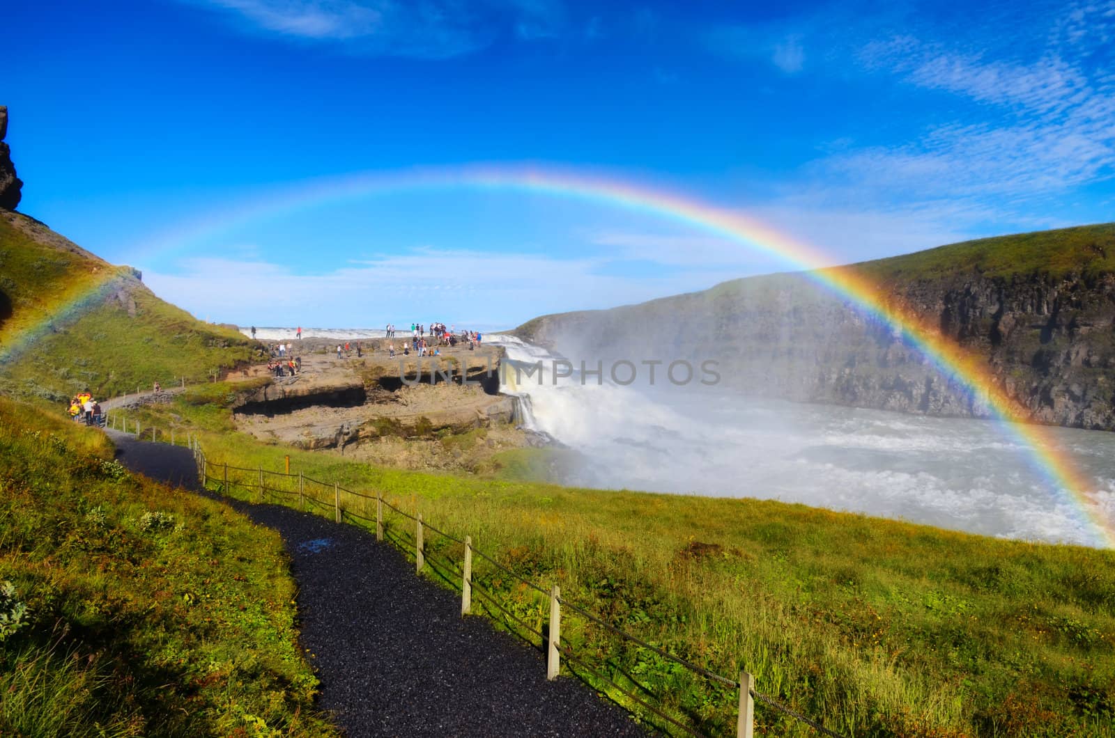 Gullfoss wild waterfall, strong running water and rainbow, daylight view, Iceland