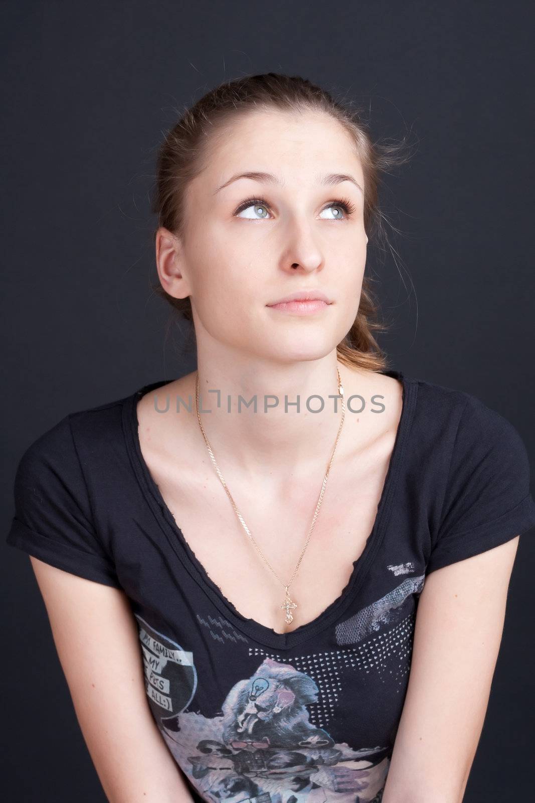 Pensive dreamy girl looks up studio photography