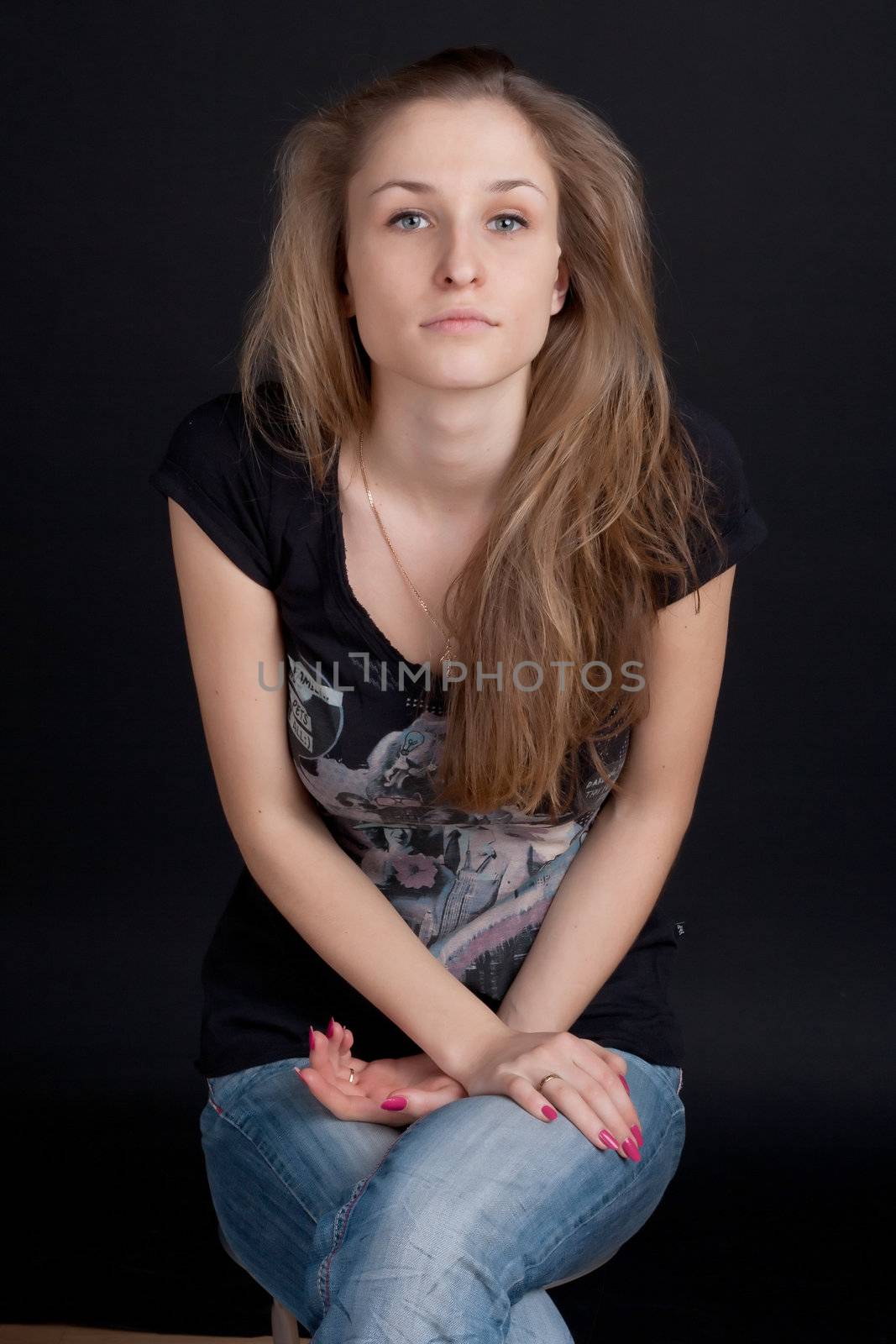 Smiling girl sitting on a stool studio photography
