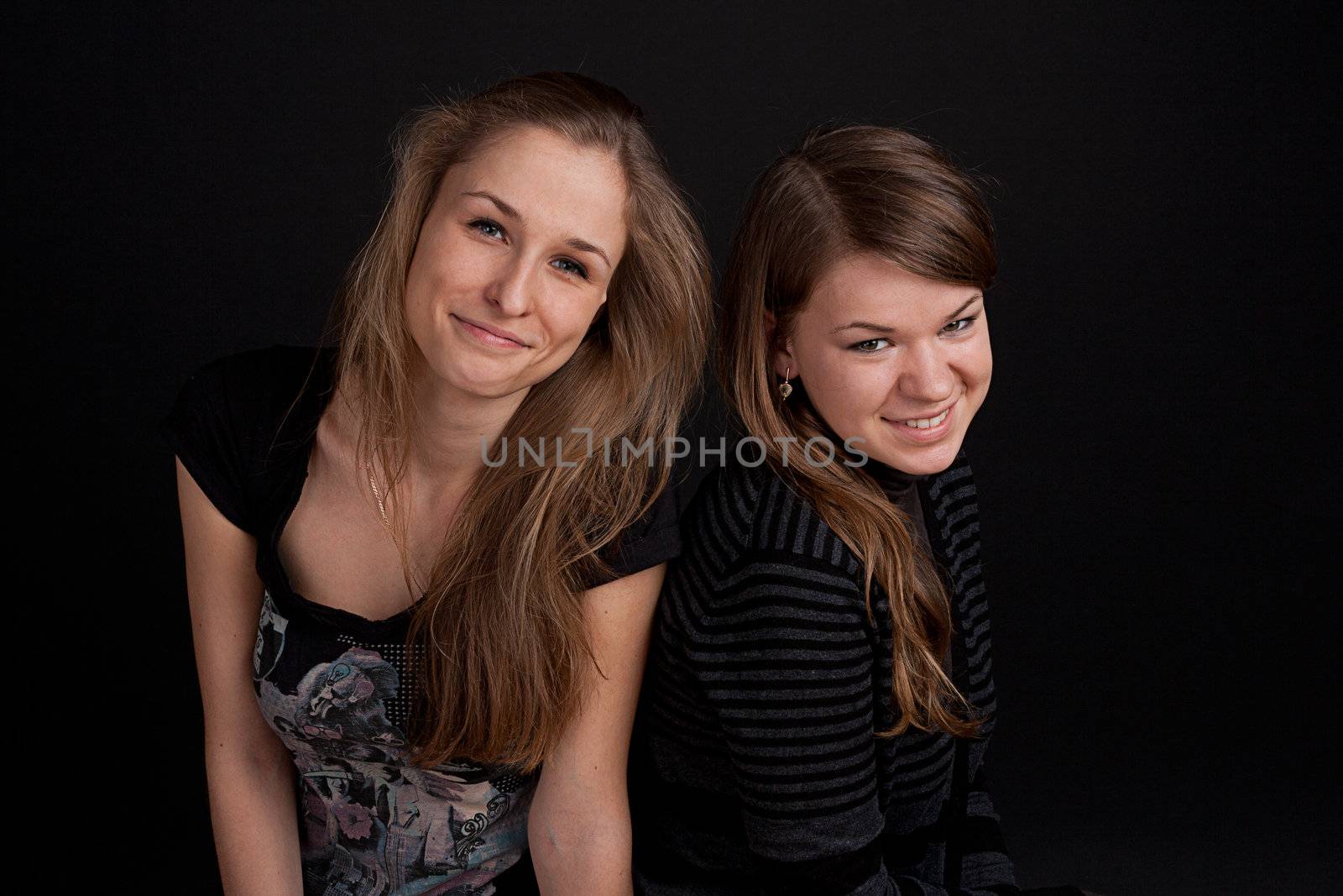 two friends talking and smiling studio shot