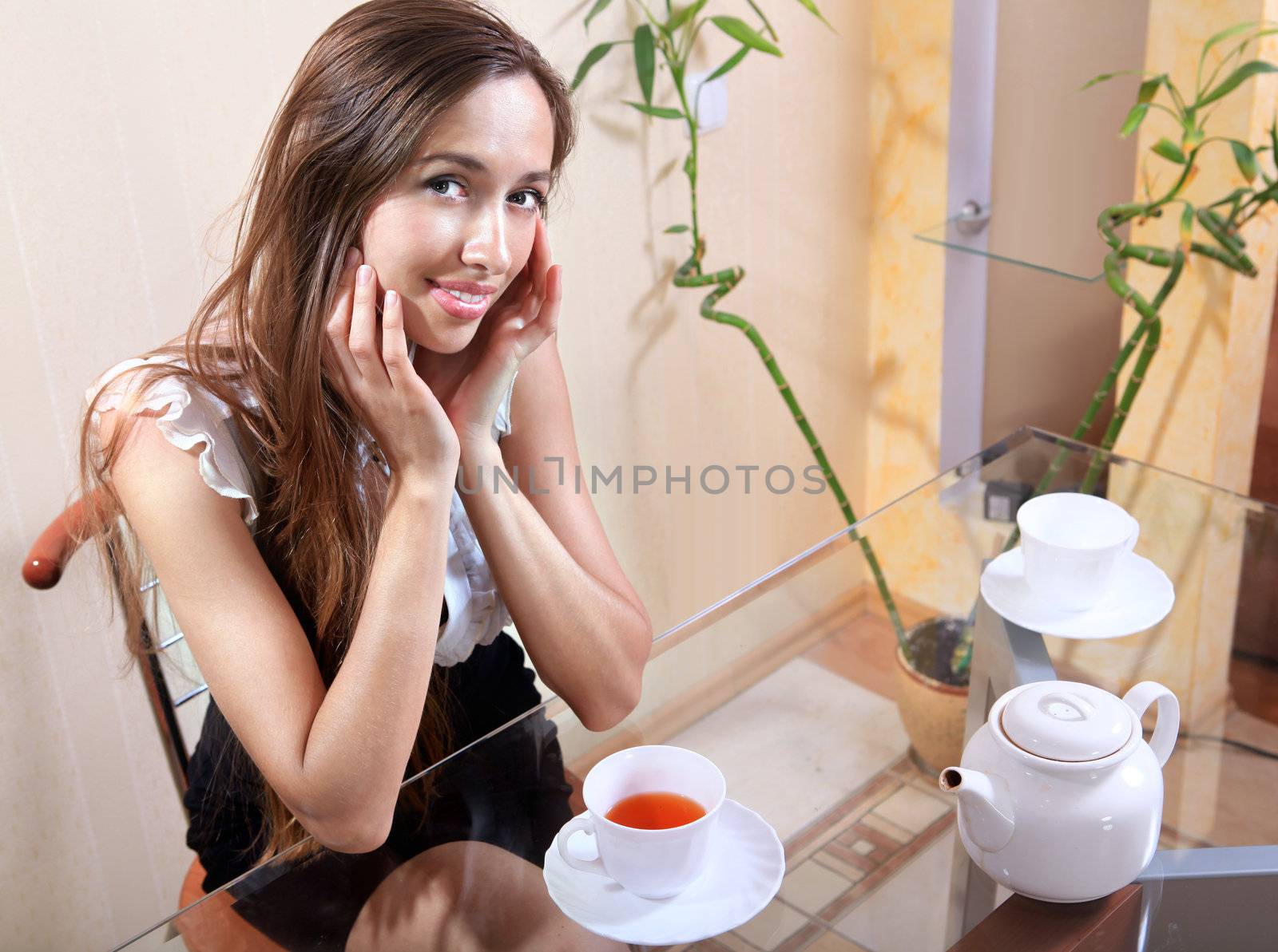 Portrait of beautiful brunette woman drinking tea in cafeteria