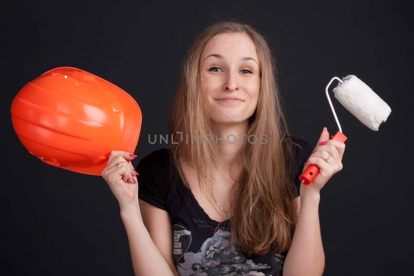 the girl is holding an orange helmet and cushion