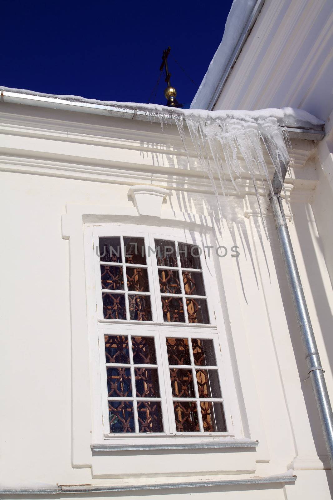icicles on roof of the white building