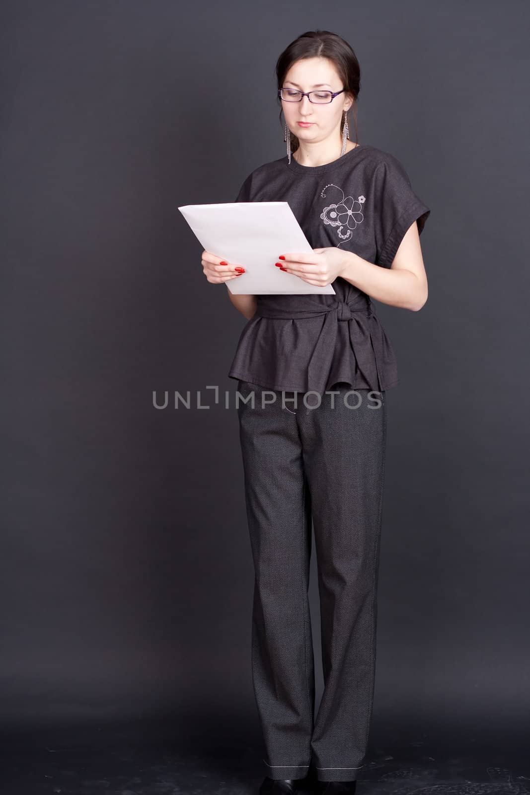 businesswoman with documents in hand with glasses studio photography