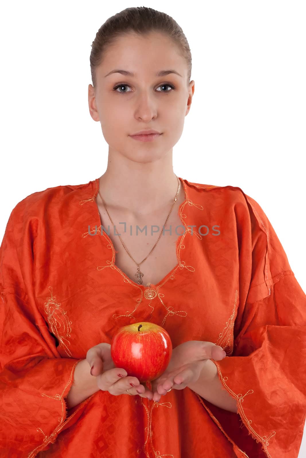 Girl in orange dress offers a red apple studio photography