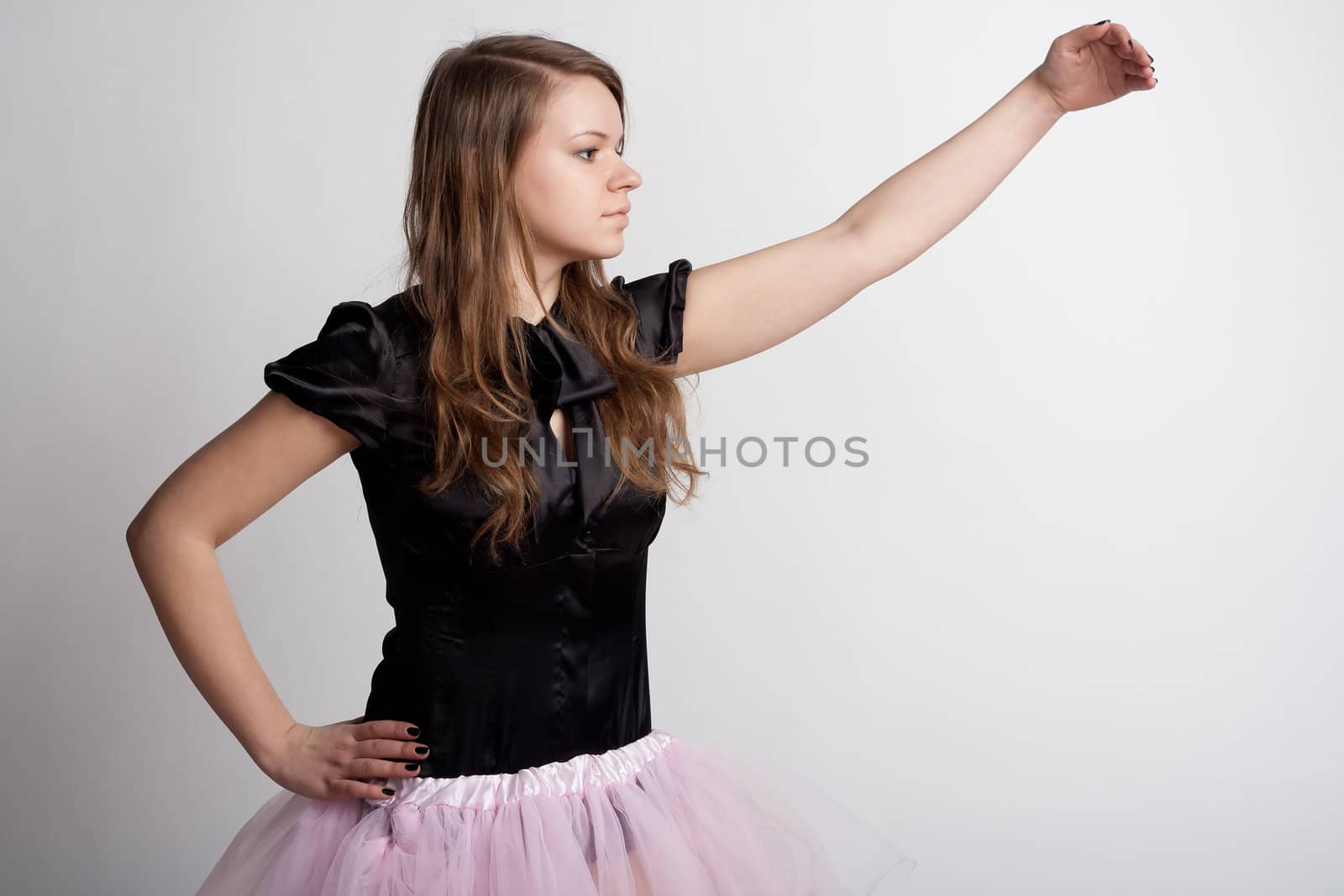Young girl in a pink skirt on a light background