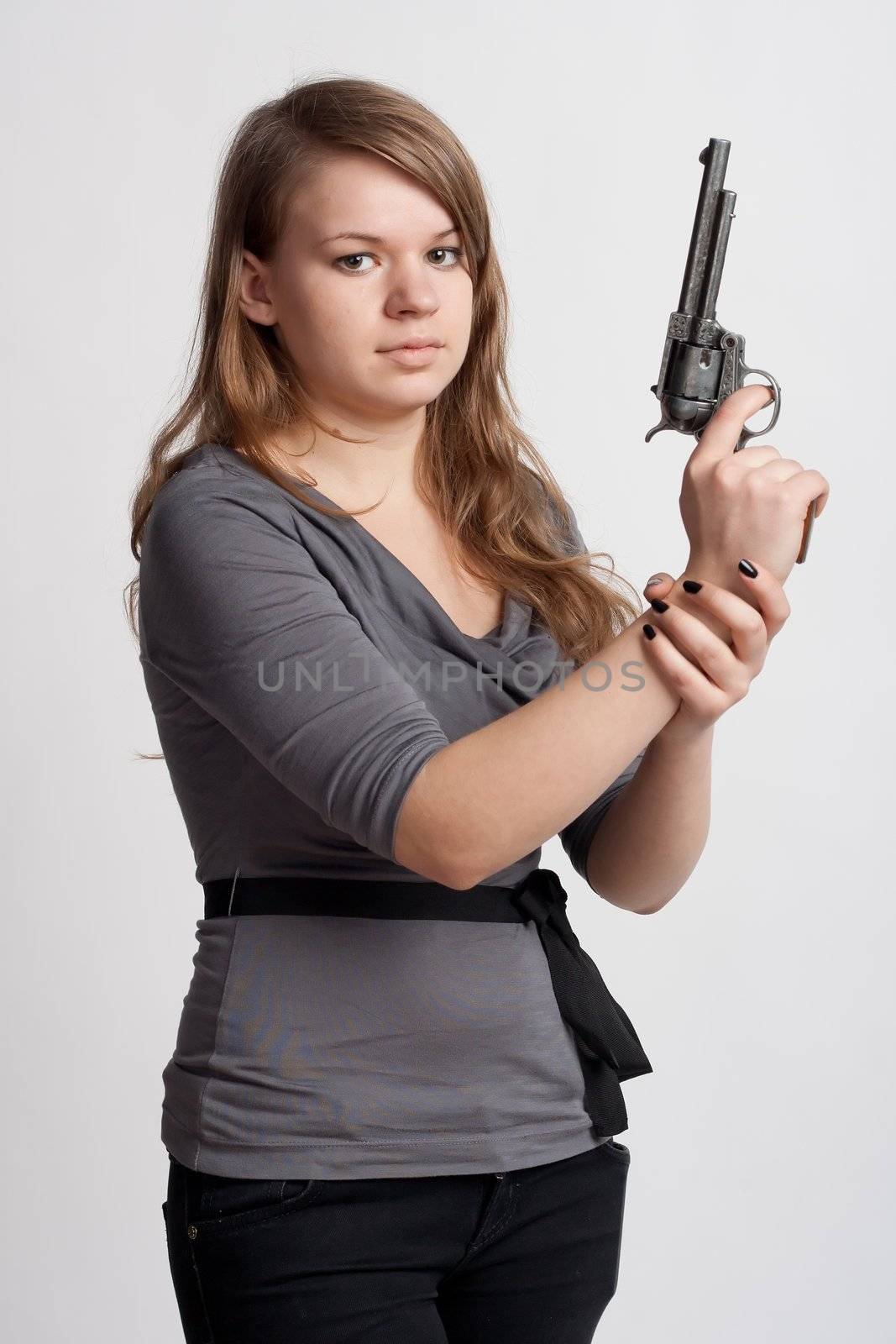 girl with a gun on a light background