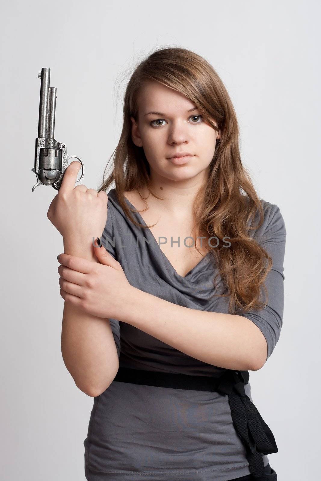 girl with a gun on a light background