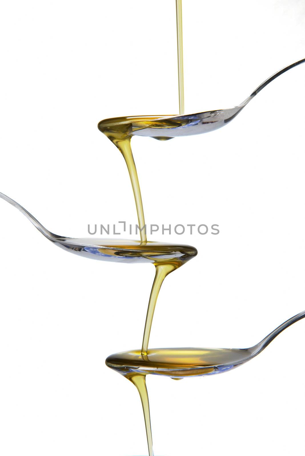 Spoons and olive oil falling by angelsimon