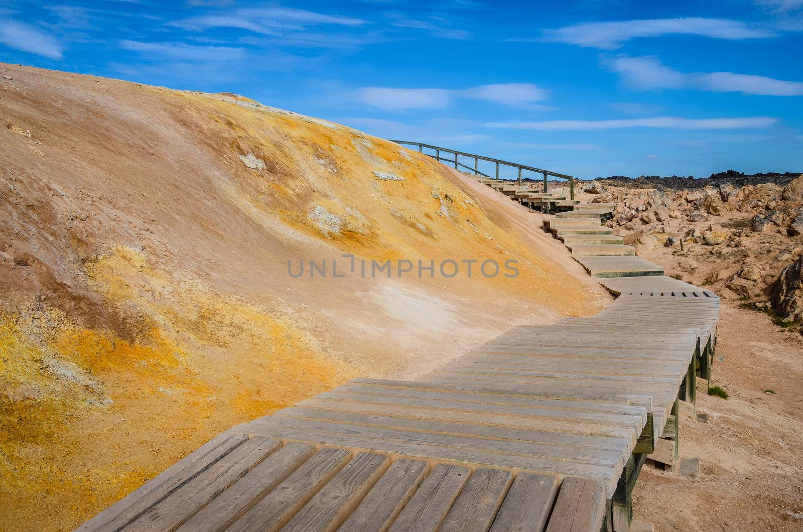 Wooden path in colorful geothermal field near Myvatn lake, Iceland