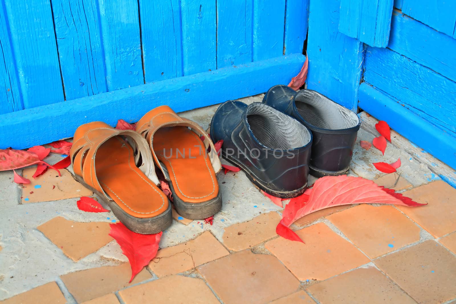 aging footwear on porch of the rural building