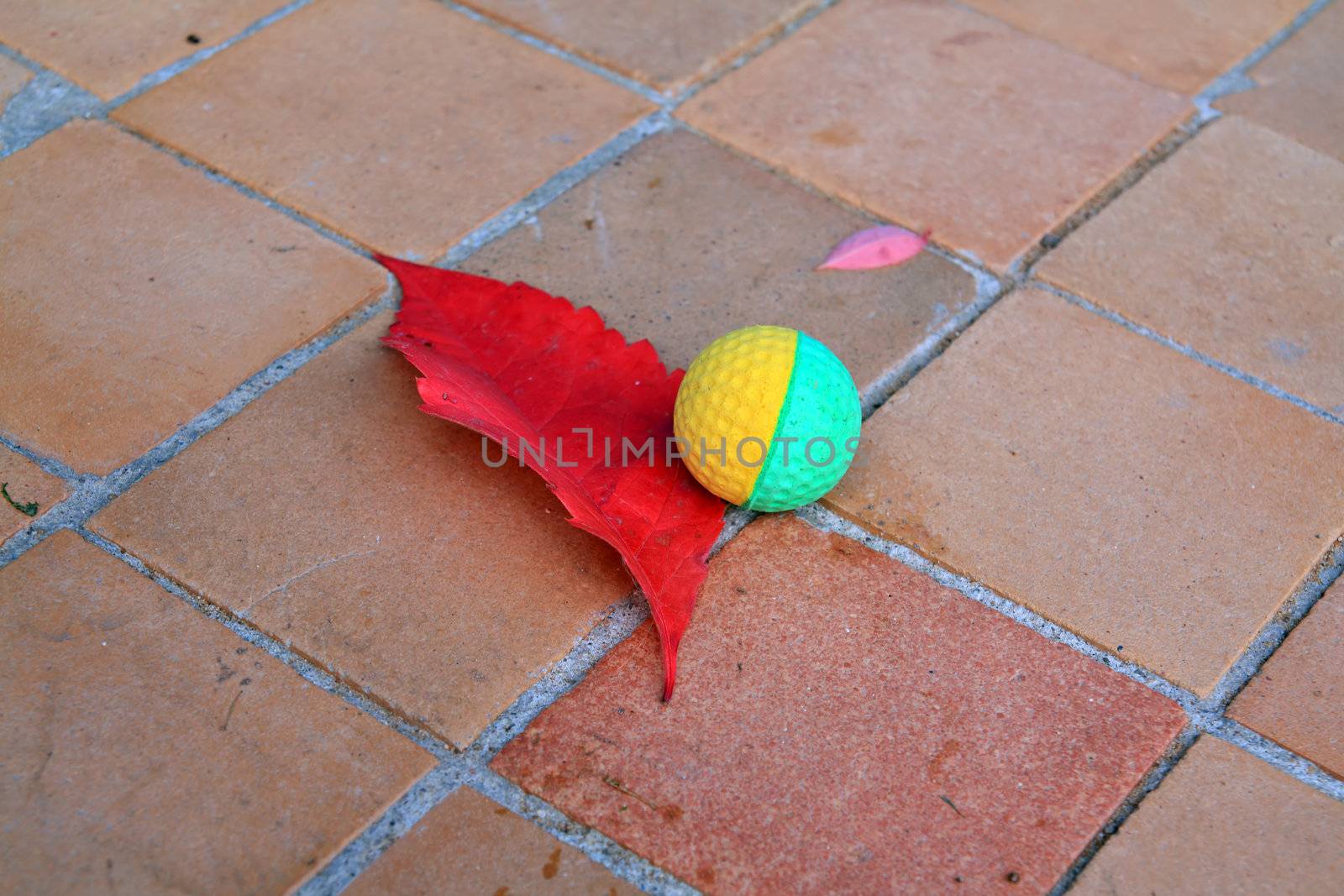 ball near red sheet on tiled floor by basel101658