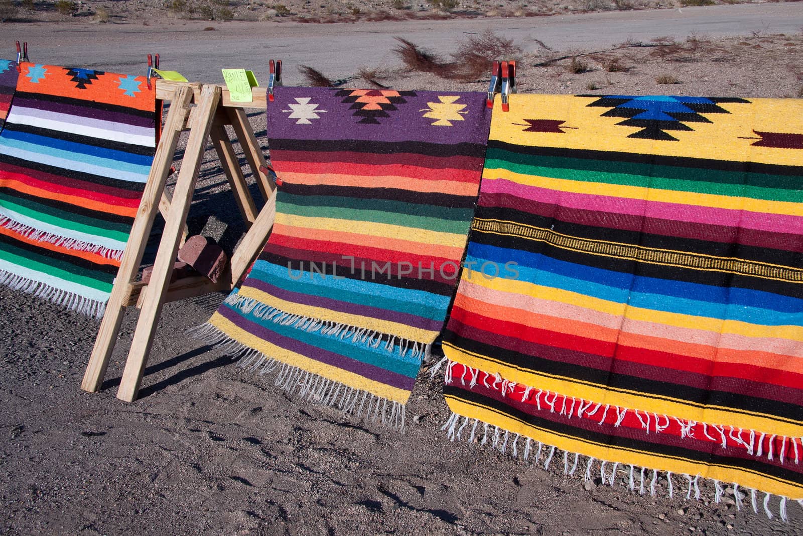 Indian rug on display on the side of the road