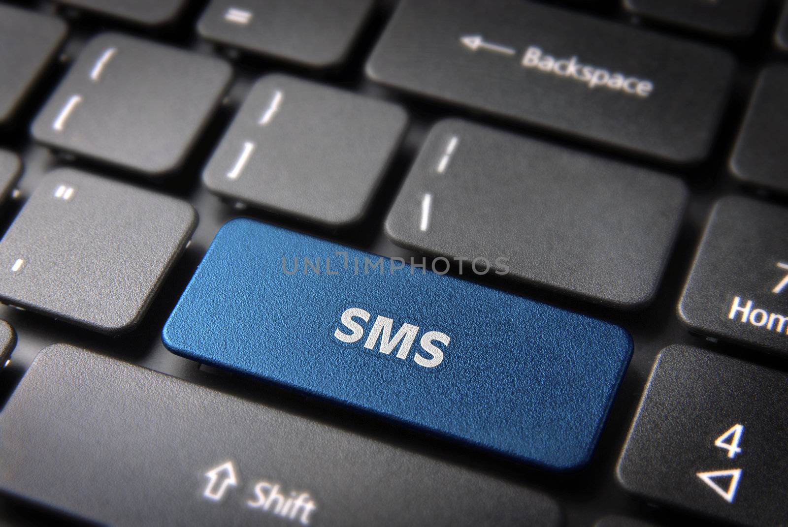 Social media key with SMS text on laptop keyboard. Included clipping path, so you can easily edit it.