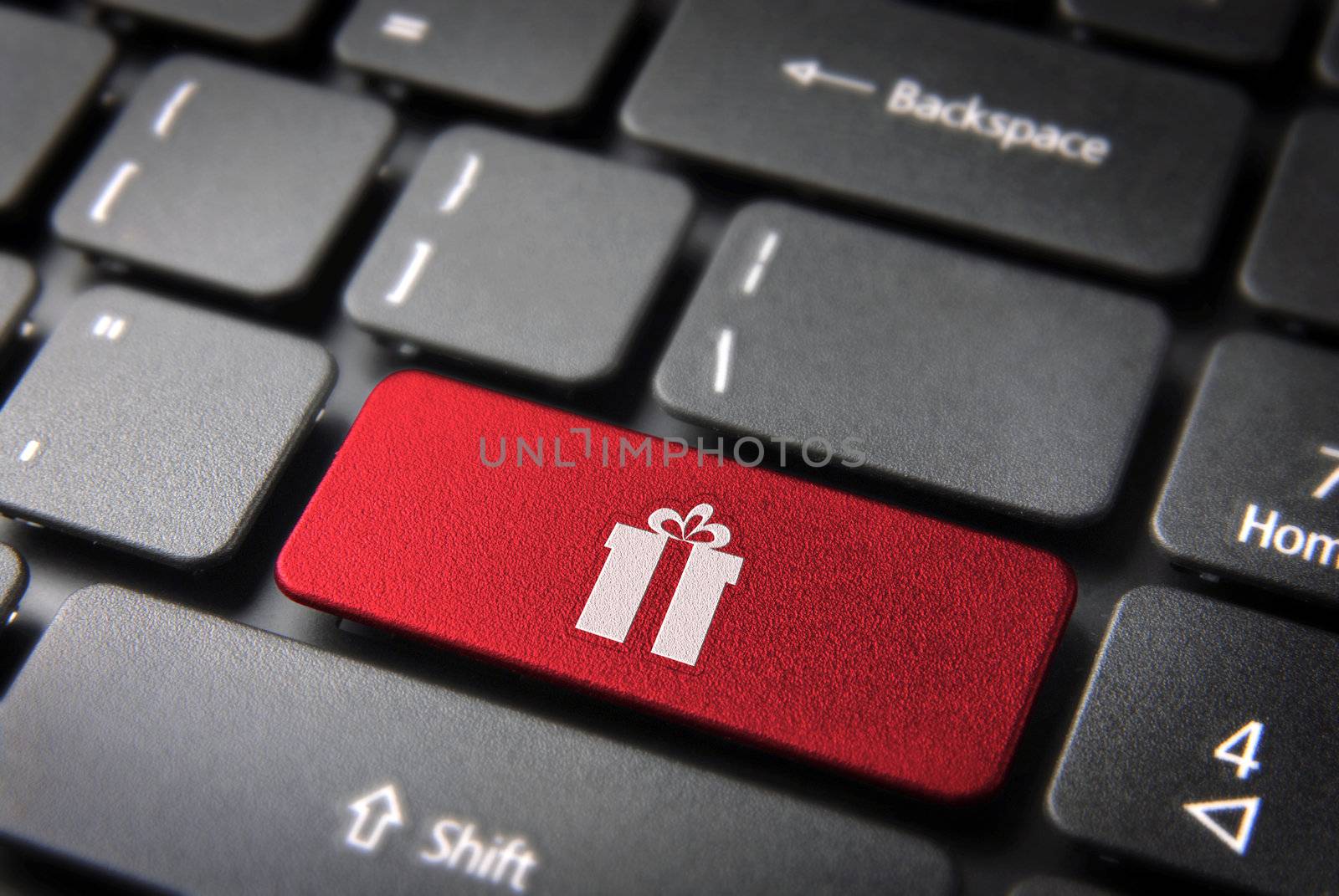 Red Christmas key with gift box icon on laptop keyboard. Included clipping path, so you can easily edit it.
