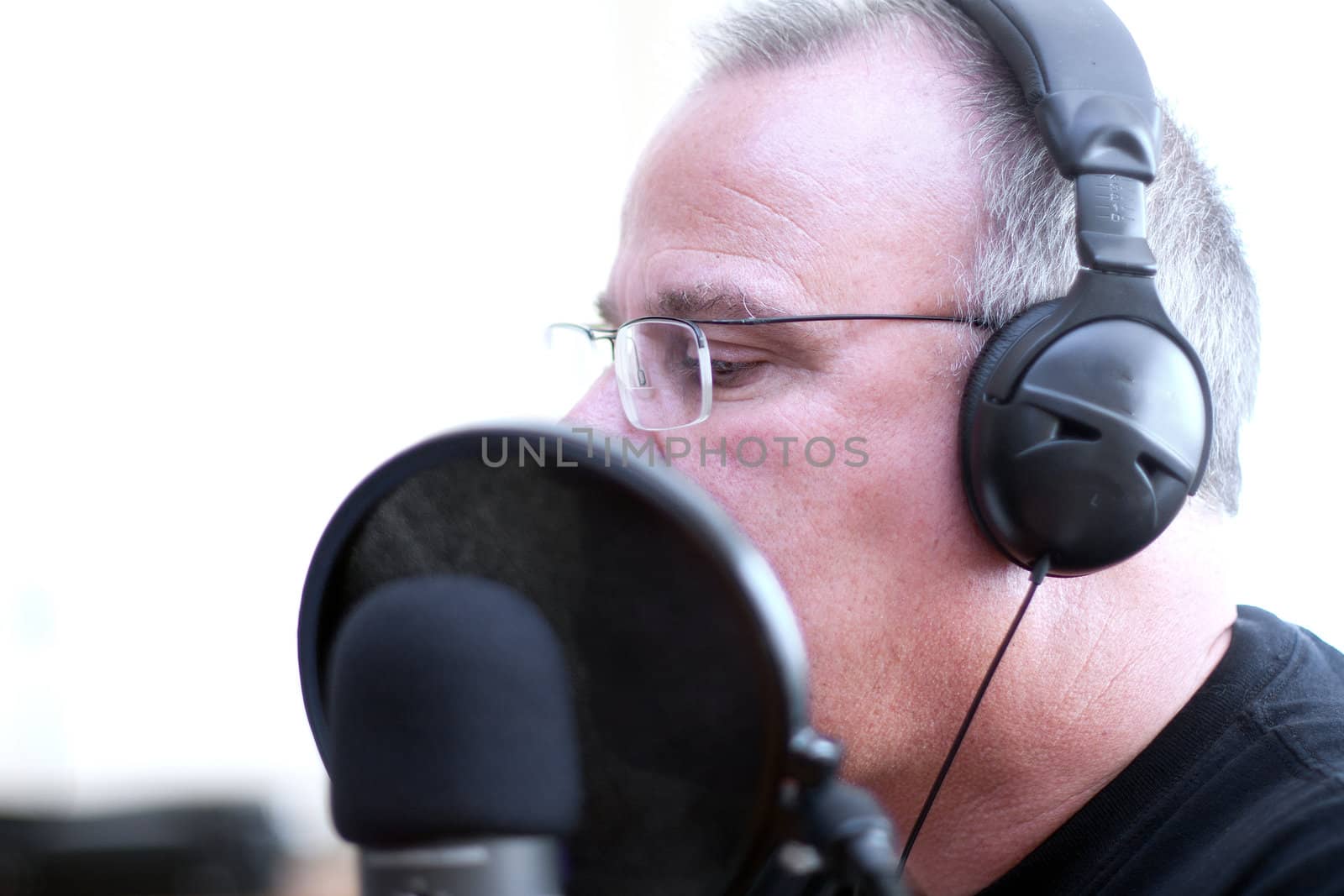 Radio DJ host with head phones and mic