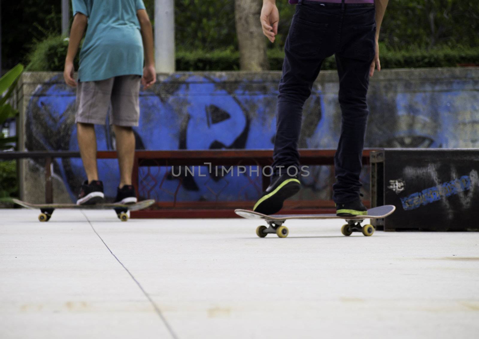 feet and skates riding on a skateboards in the park 