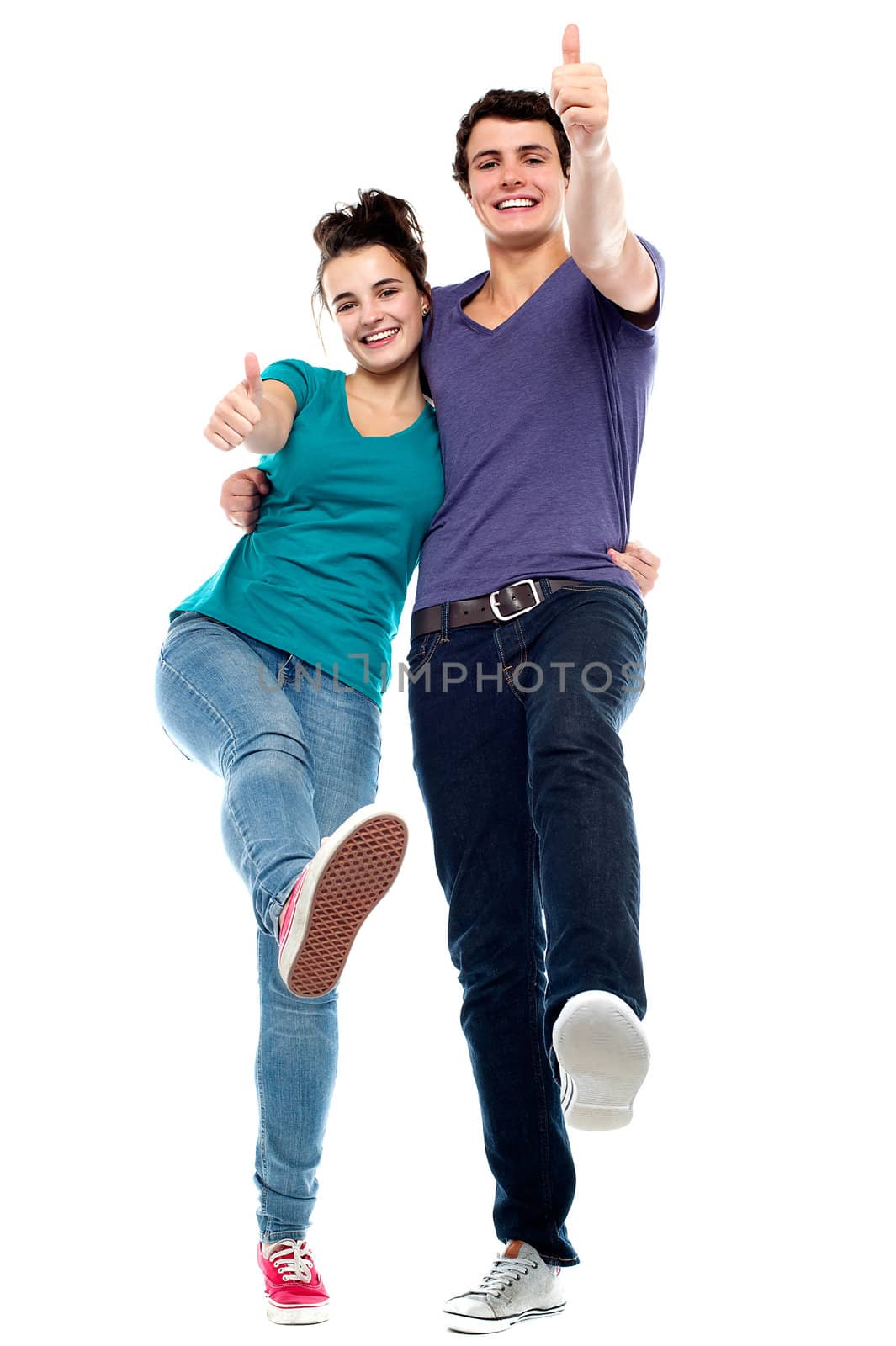 Teen love couple enjoying themselves, gesturing thumbs up. All against white background