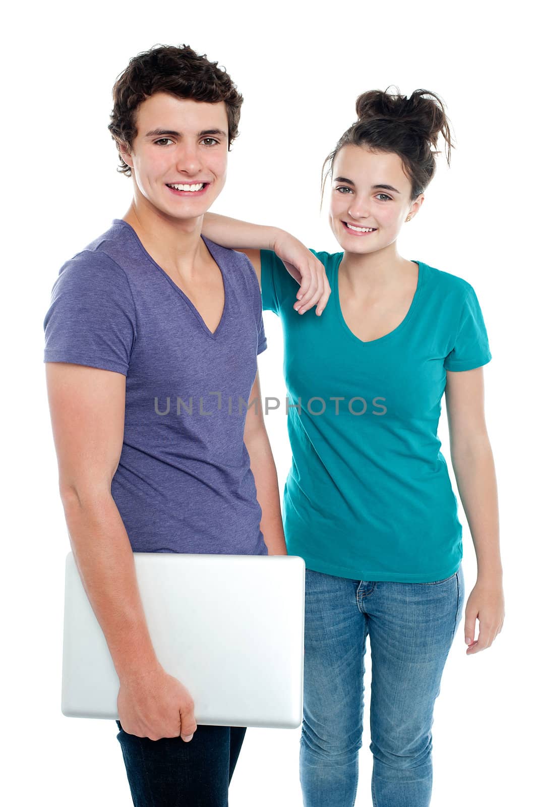 Handsome guy holding laptop posing with his girlfriend. Indoor shot
