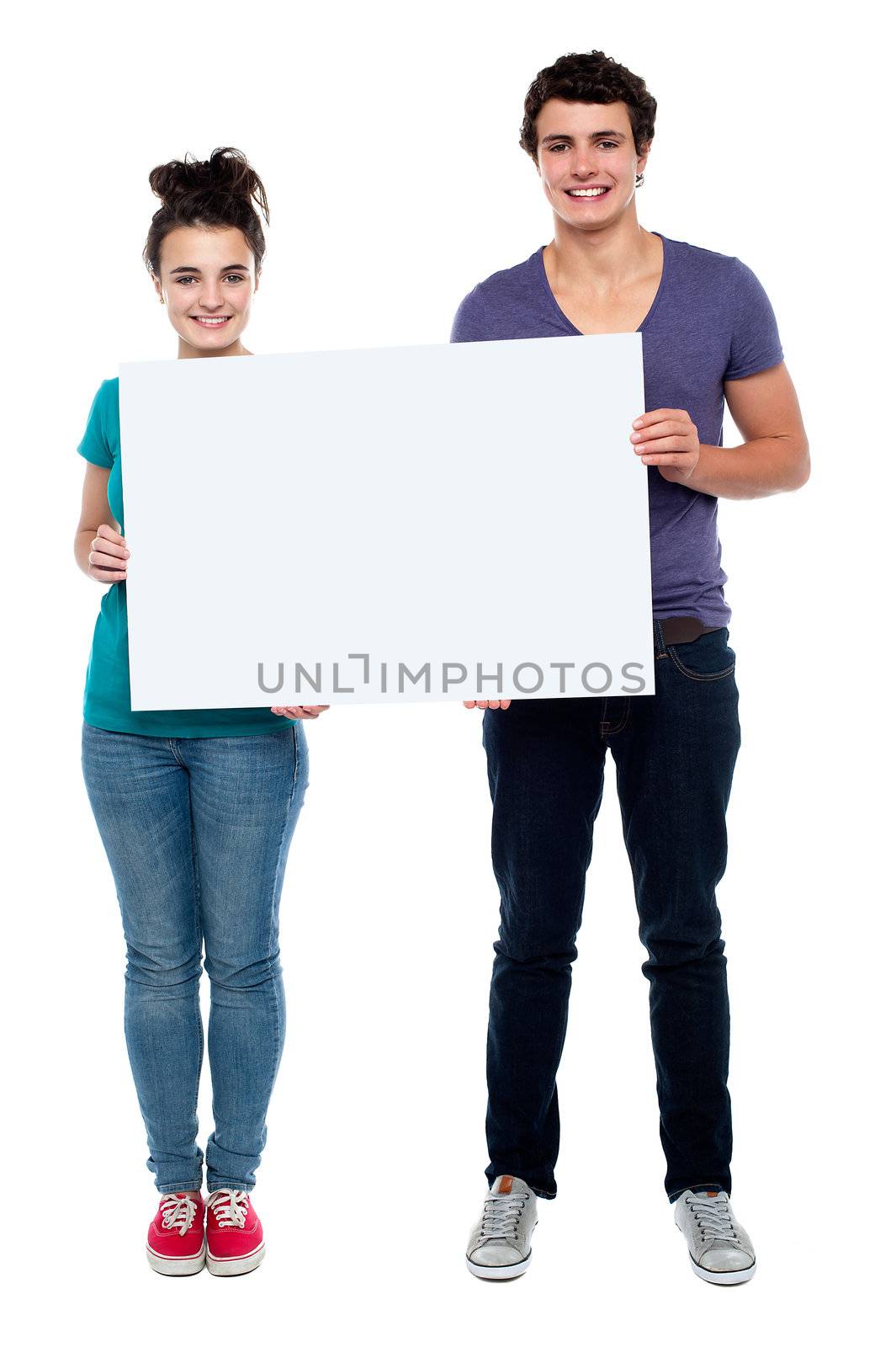 Full length portrait teen couple posing with blankbill board