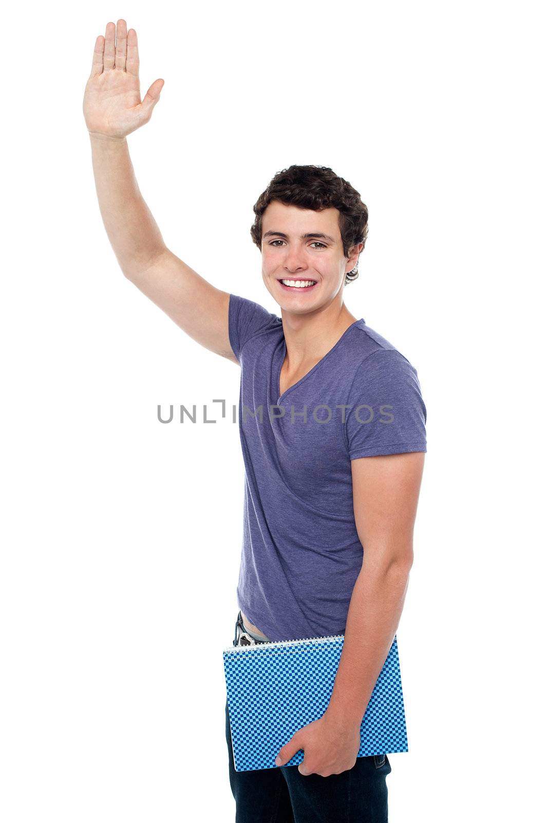 Handsome young guy with a notebook in hand putting his right hand up isolated over white