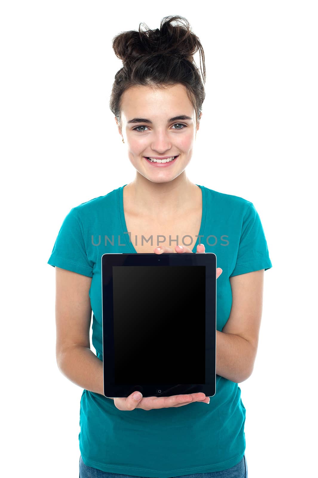 Casual teenager showing newly launched tablet device to the camera