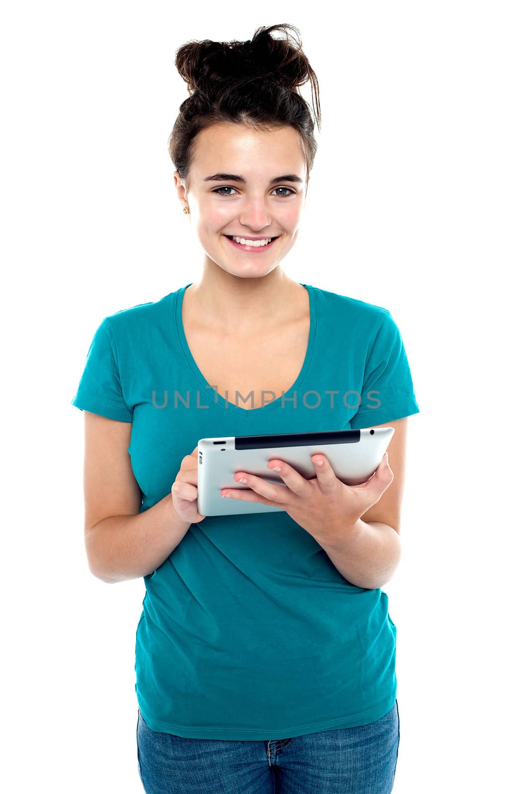 Pretty young brunette using wireless tablet device isolated against white background