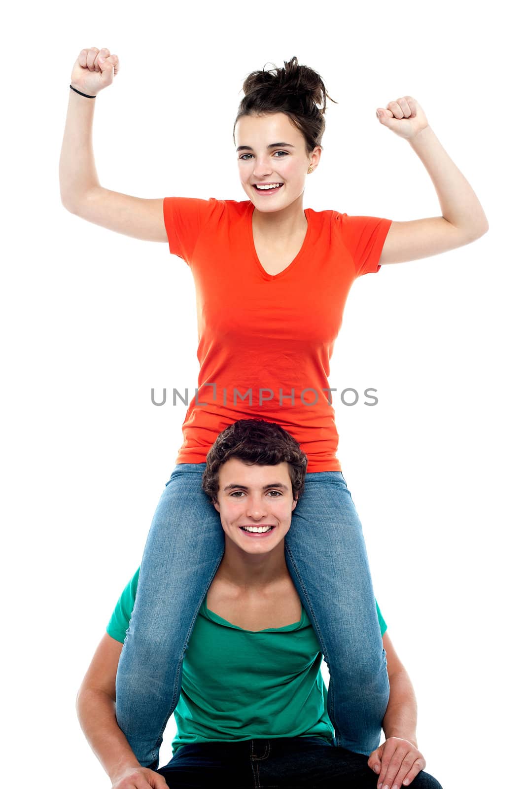 Excited pretty girl enjoying riding on his friends shoulder by stockyimages