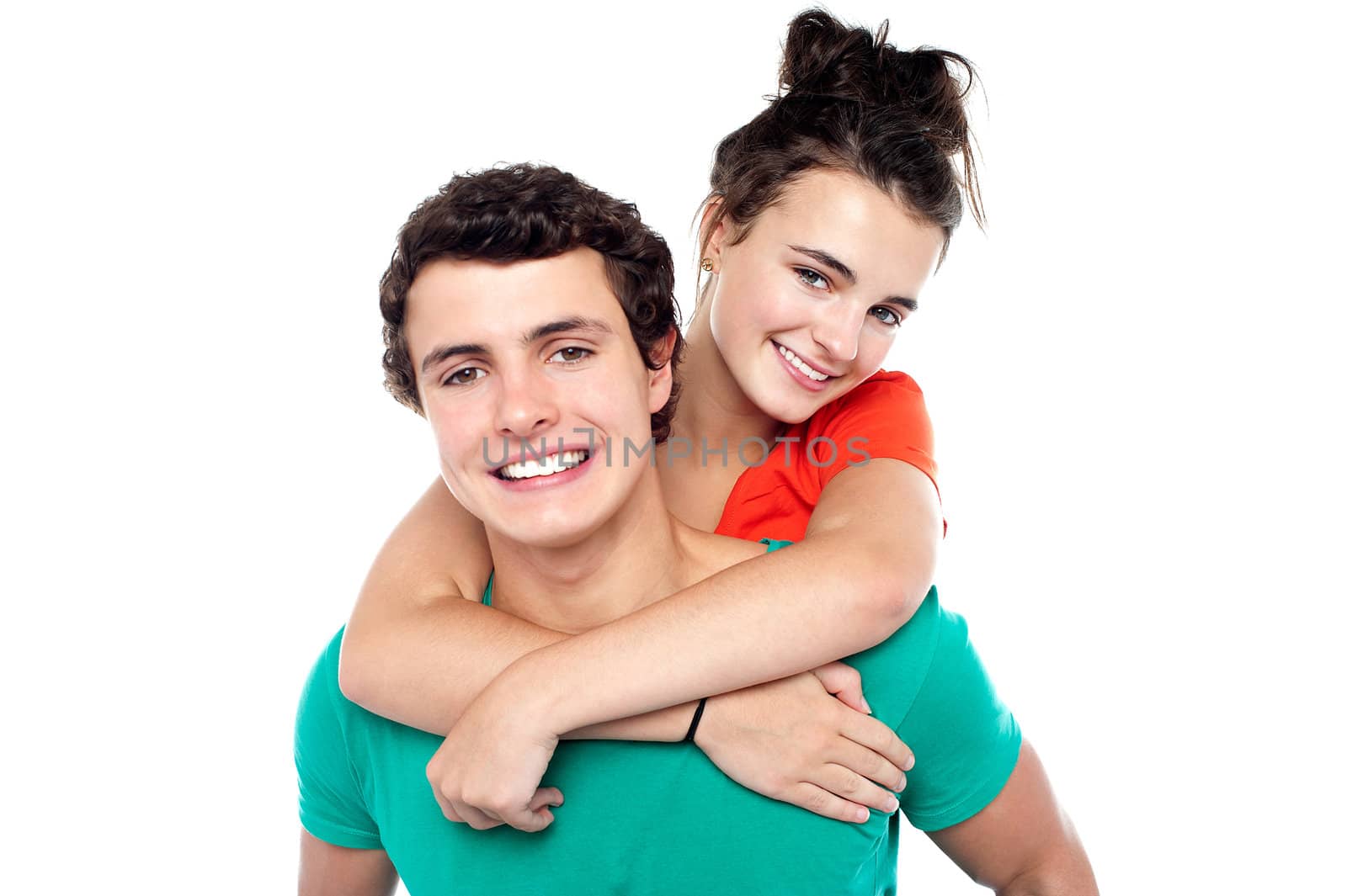 Young boy giving his girlfriend piggyback ride by stockyimages
