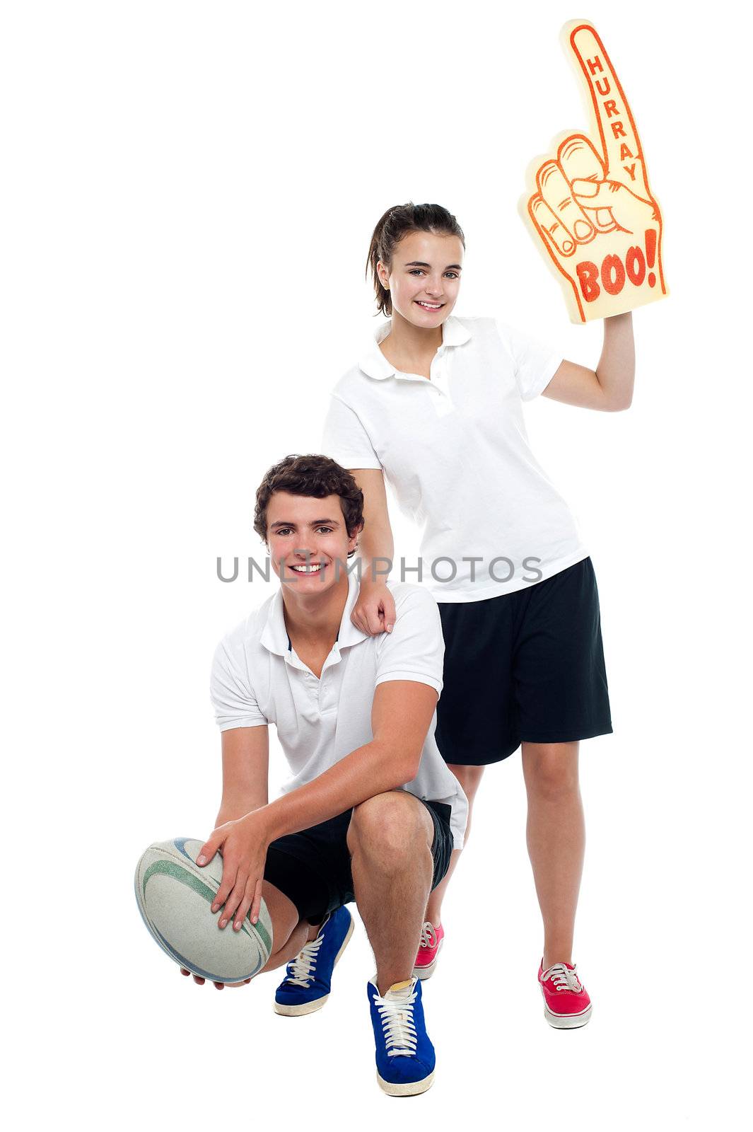 Cheerleader fan girl posing with football team player by stockyimages