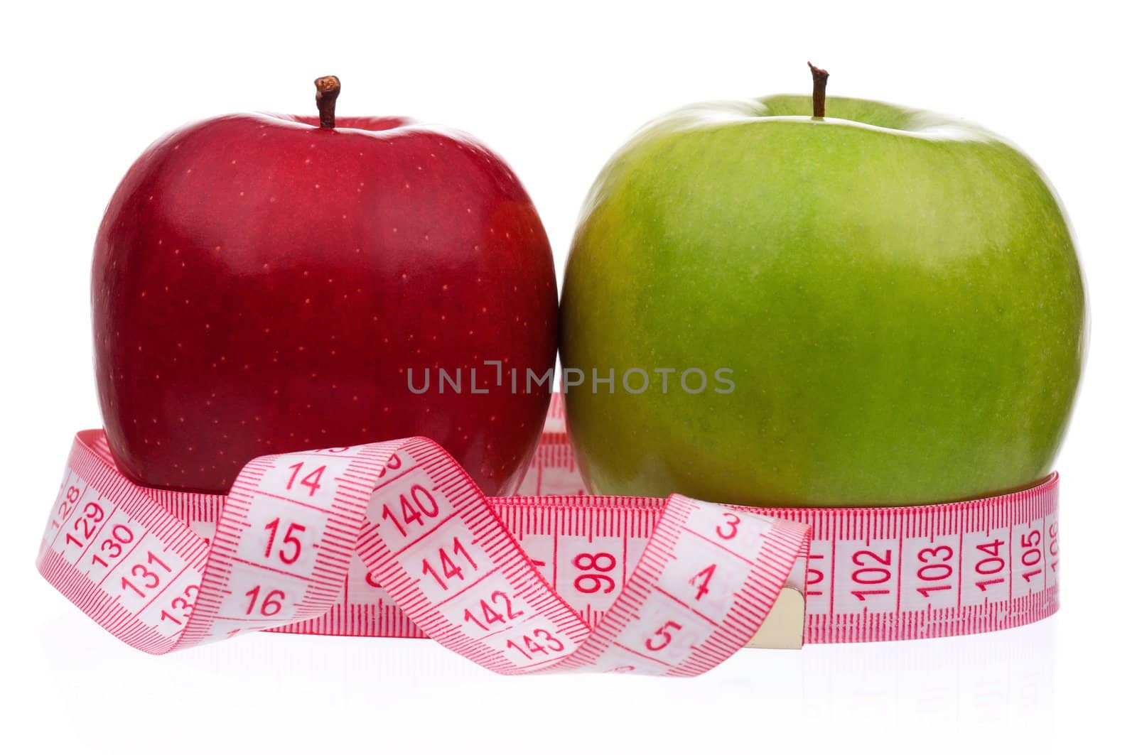 Fresh ripe apples with a measure tape wrapped around on a white background