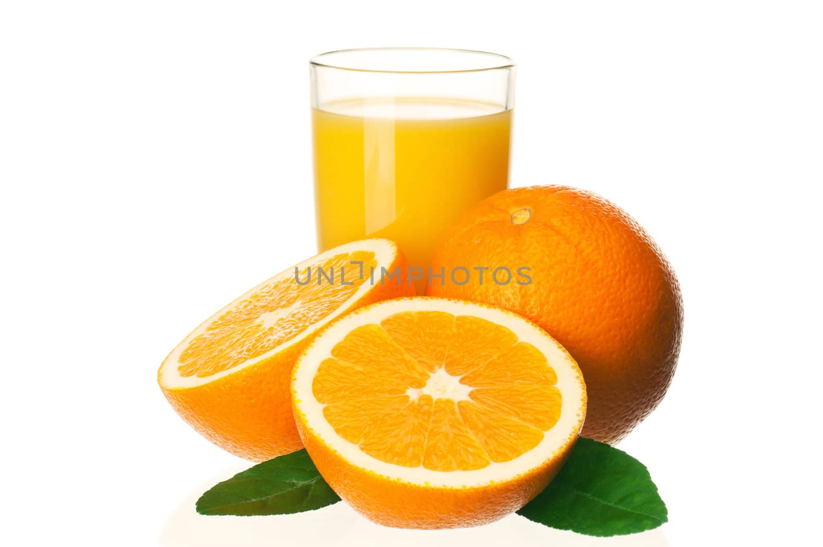 Glass of fresh orange juice and orange fruits with green leaves on white background