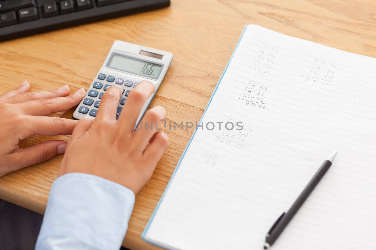 Woman calculating in her office