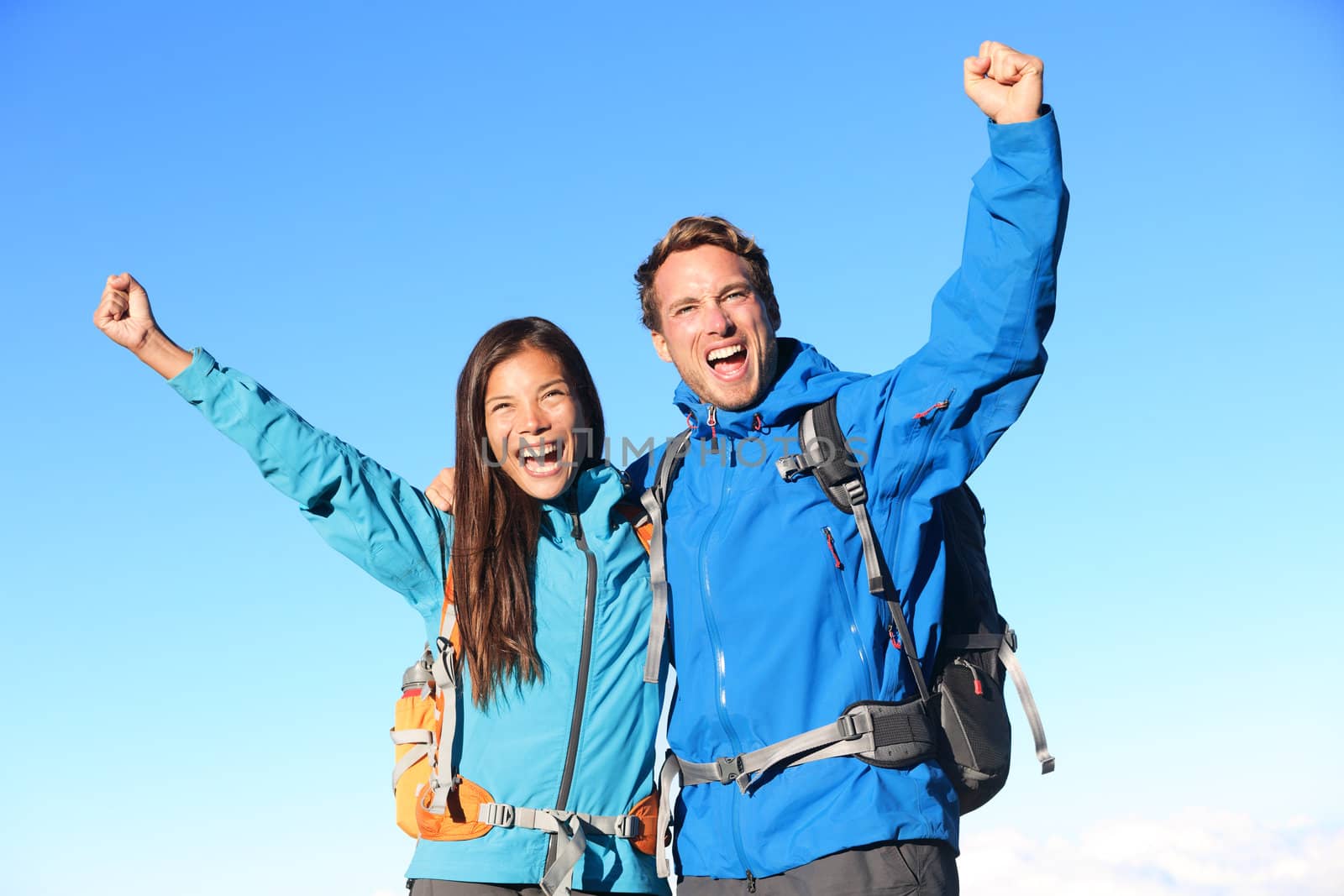 Happy hiking couple cheering by Maridav