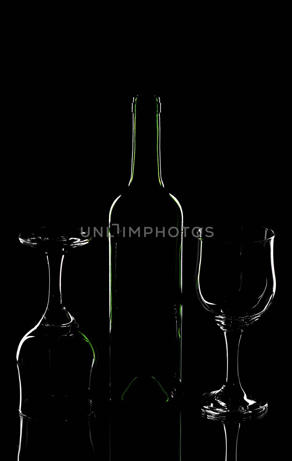Wine bottle and wine glasses on a black background