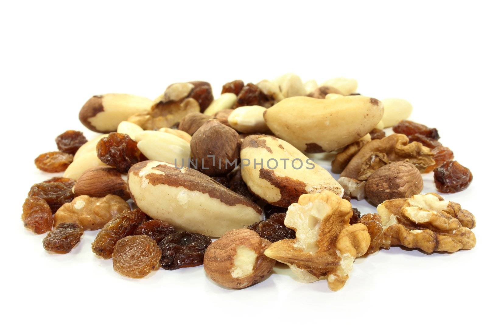 various nuts and raisins on white background