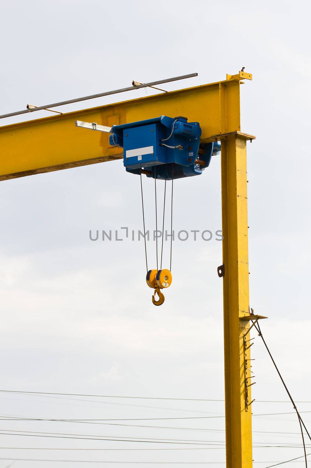 The hook of a construction crane against white background