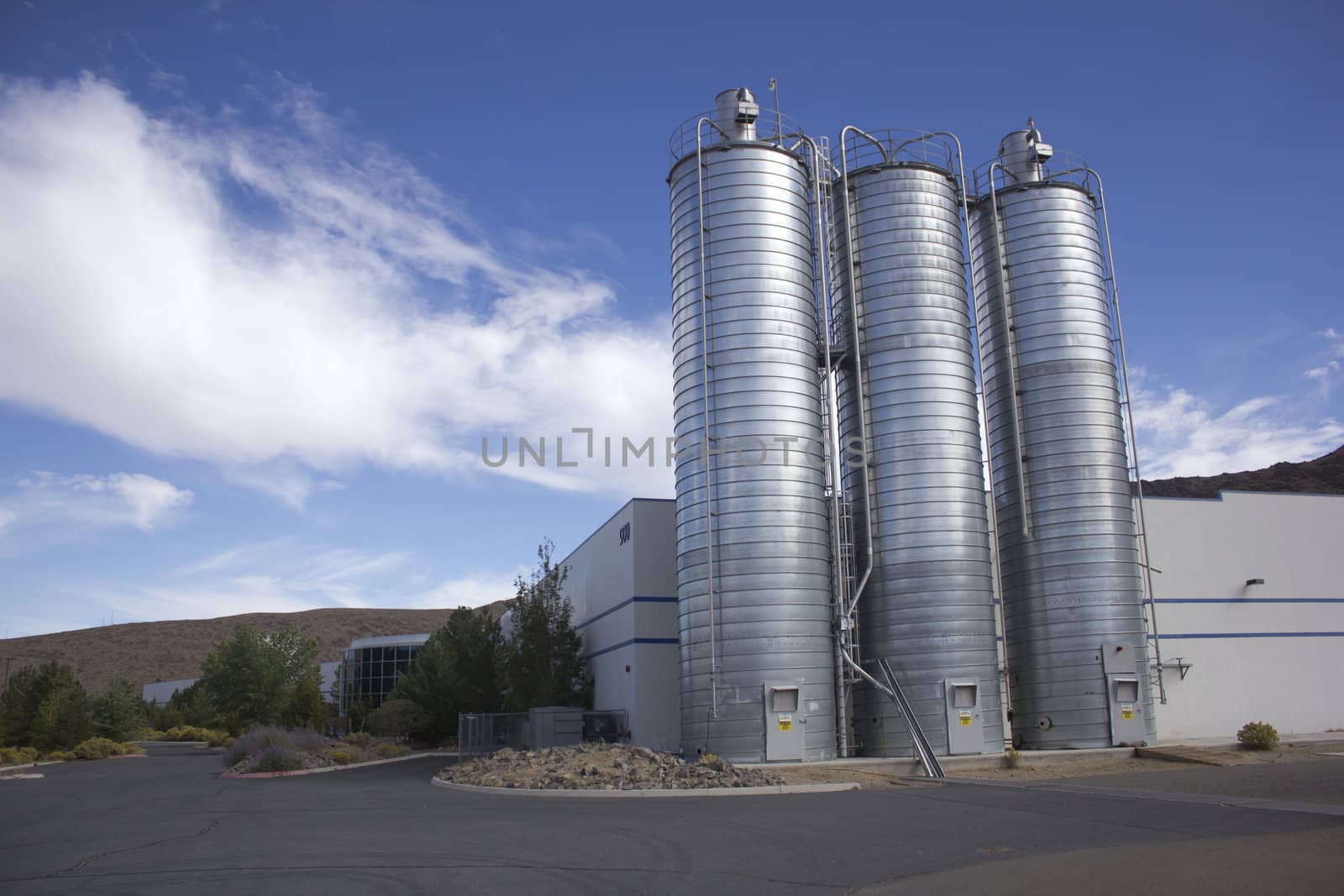 Business office or factory with silos on the side by jeremywhat