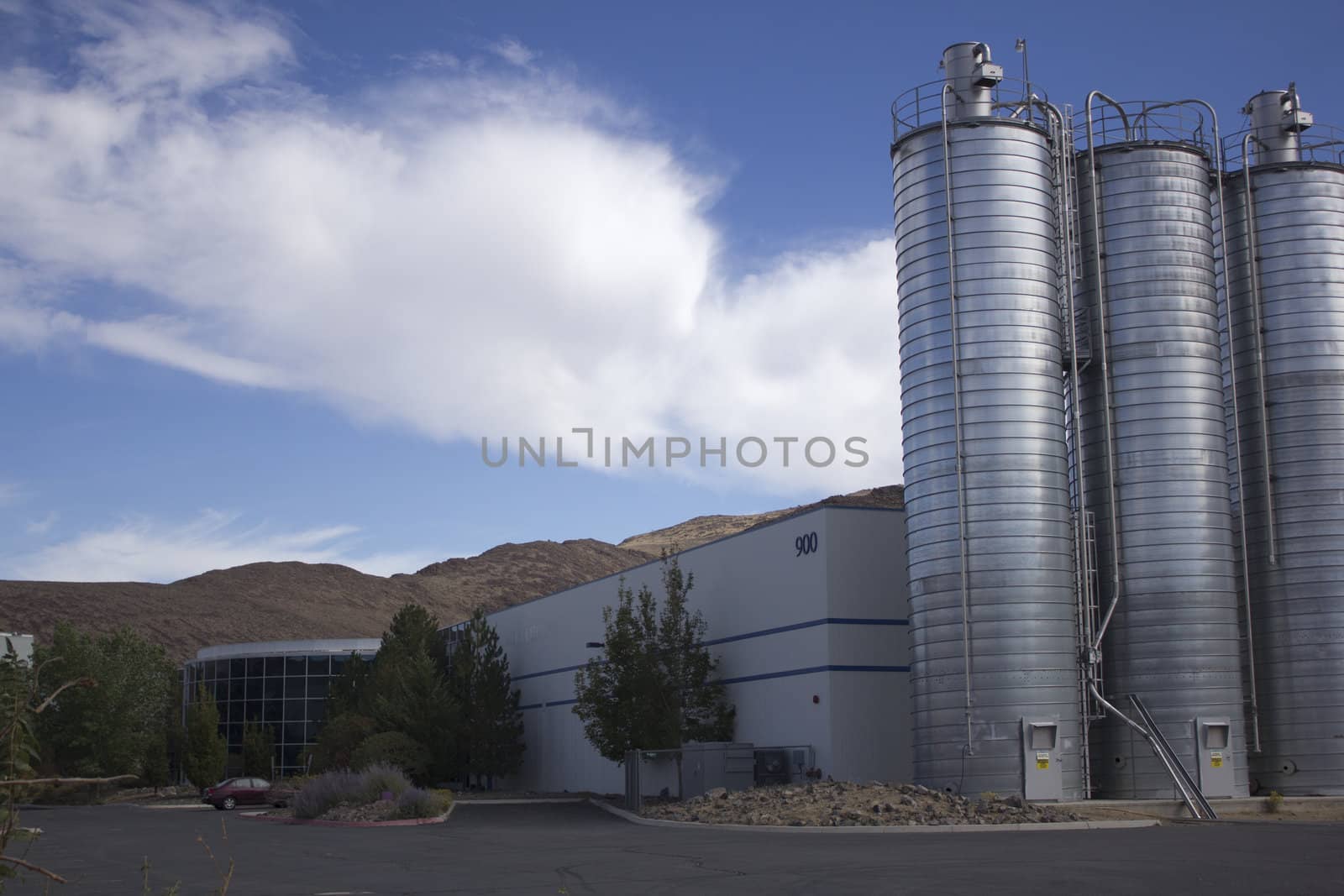 Business office or factory with silos on the side by jeremywhat