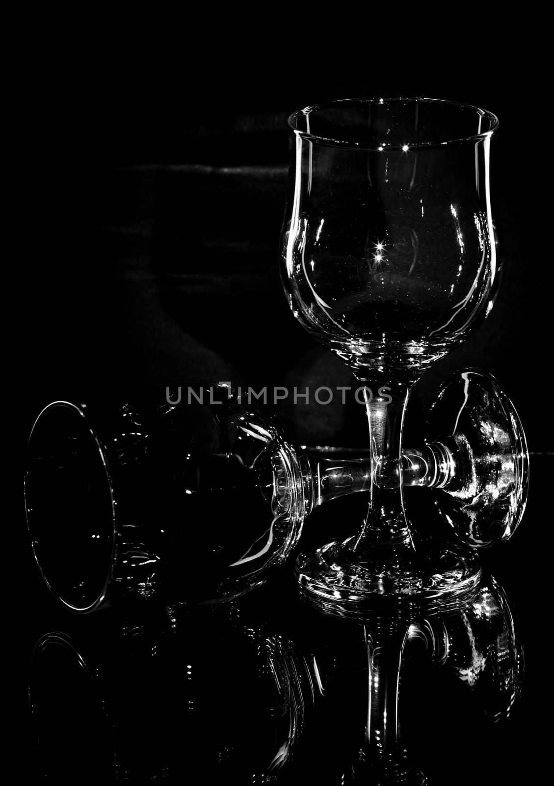 Wine glasses on a black background with reflection on glass