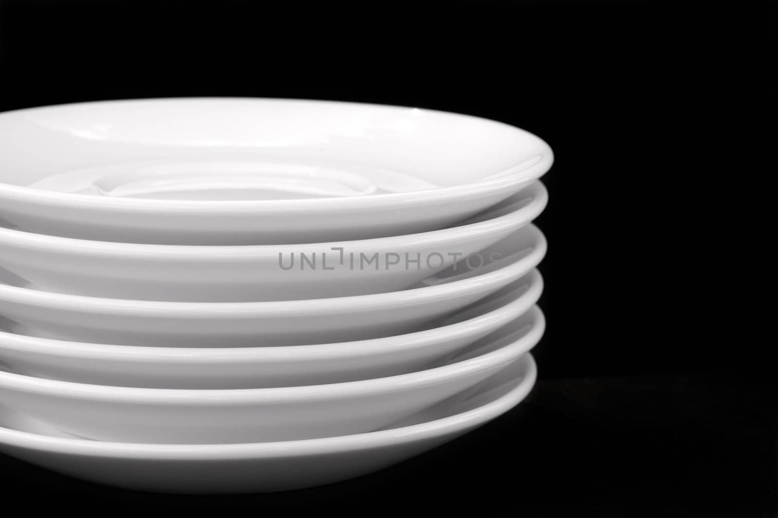 White plates isolated on black background