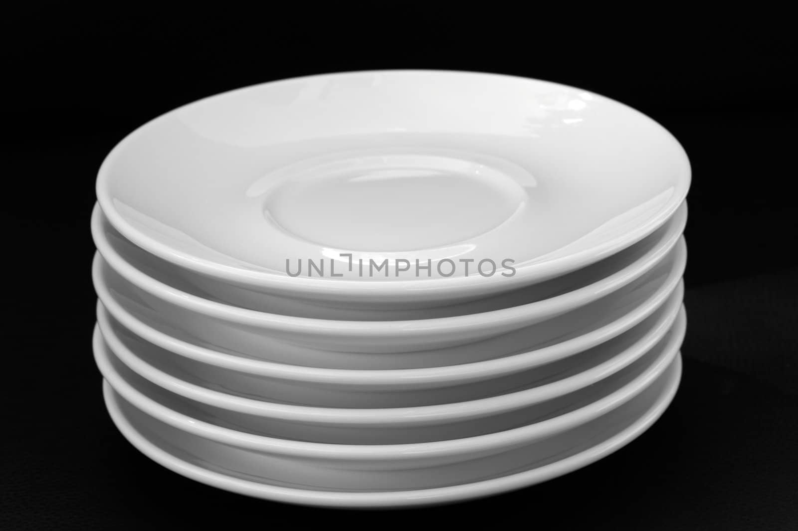 White plates isolated on black background