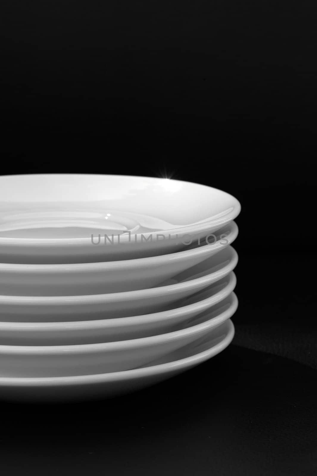 White plates isolated on black background