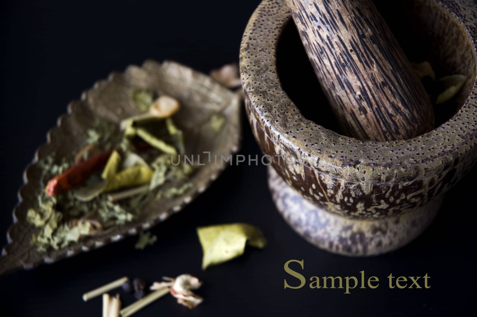 close up mortar and spices with sample text on black background